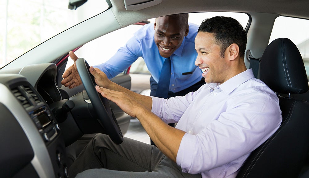 A salesperson showing a customer a feature on the dashboard